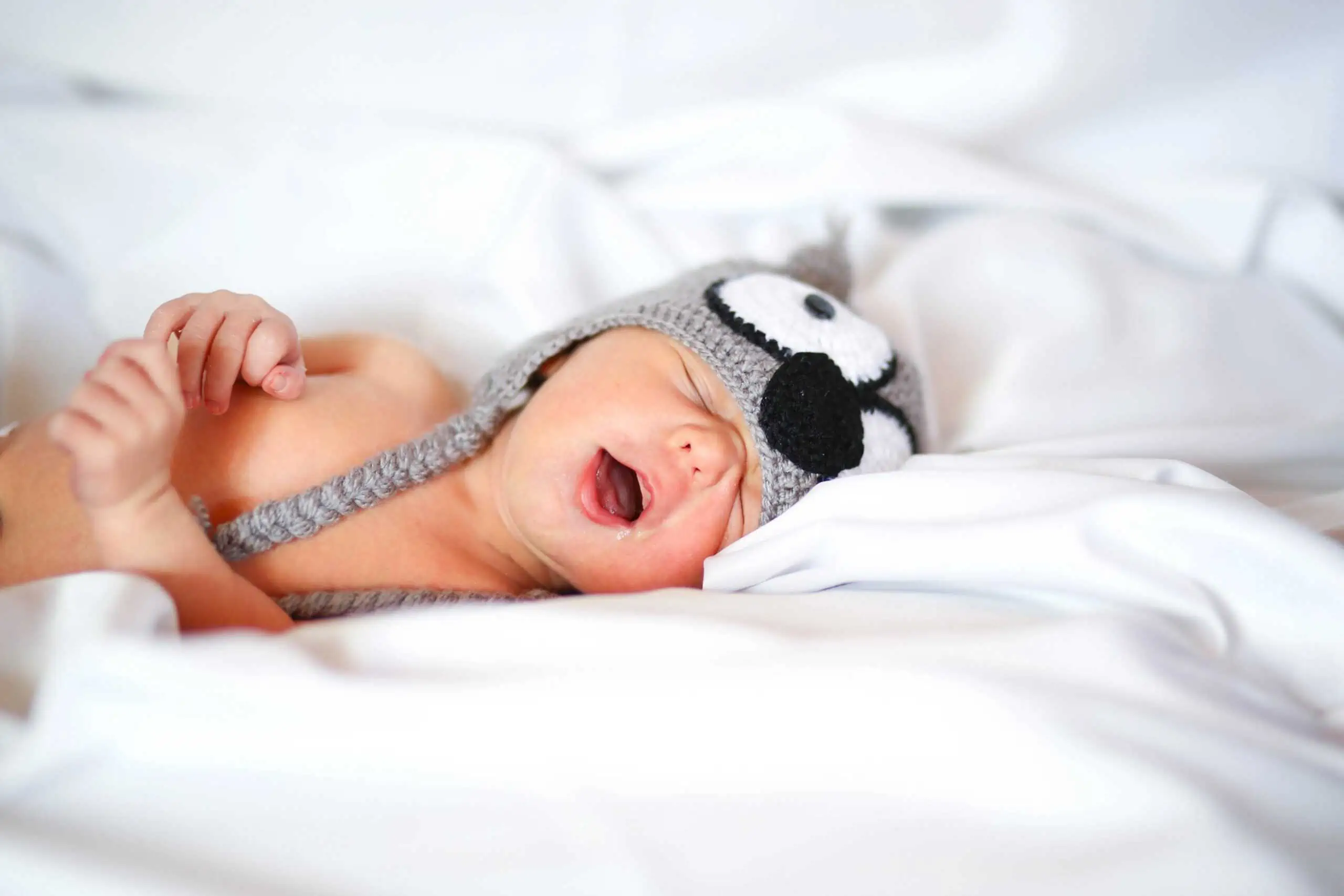 Sleeping baby with knitted headwear